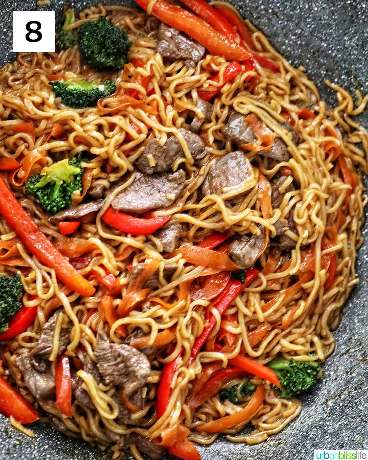 Sesame Garlic Noodles with Steak in a large wok.