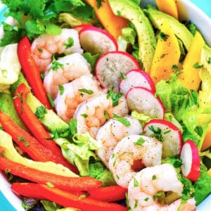 healthy shrimp salad with colorful veggies.