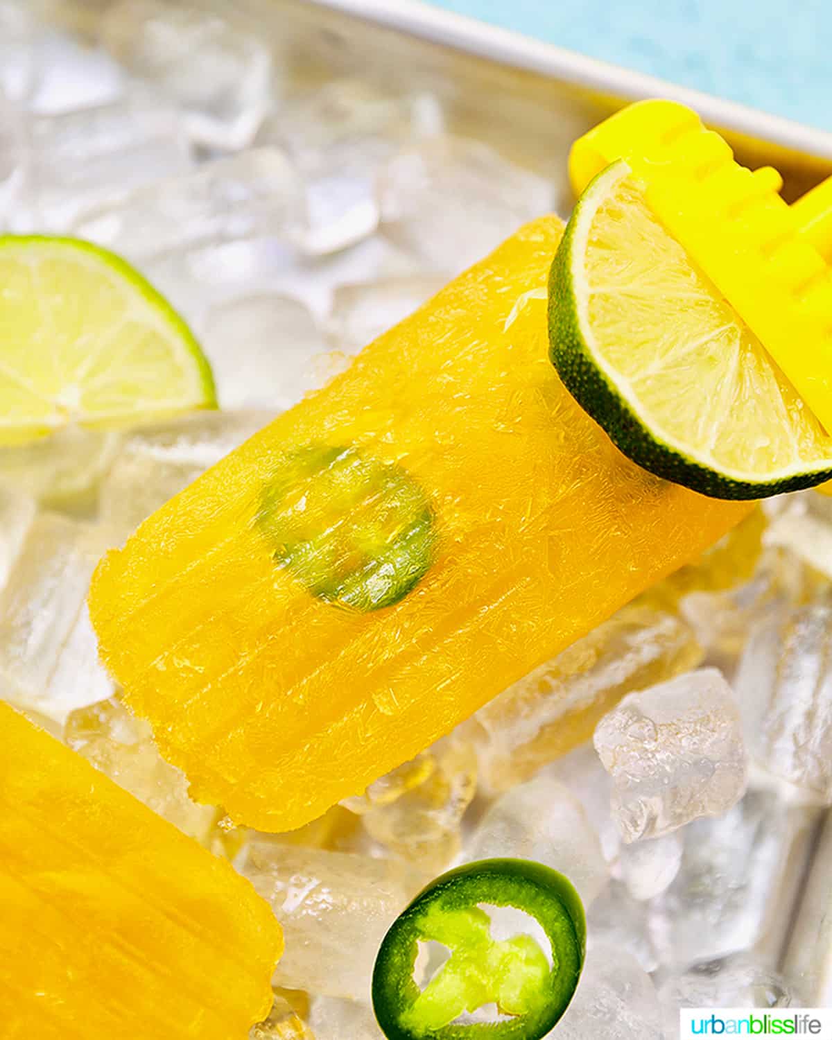 close up of a margarita popsicle over a bed of ice with jalapeno slices.