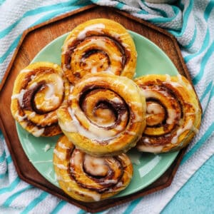 air fryer cinnamon rolls with icing drizzle.