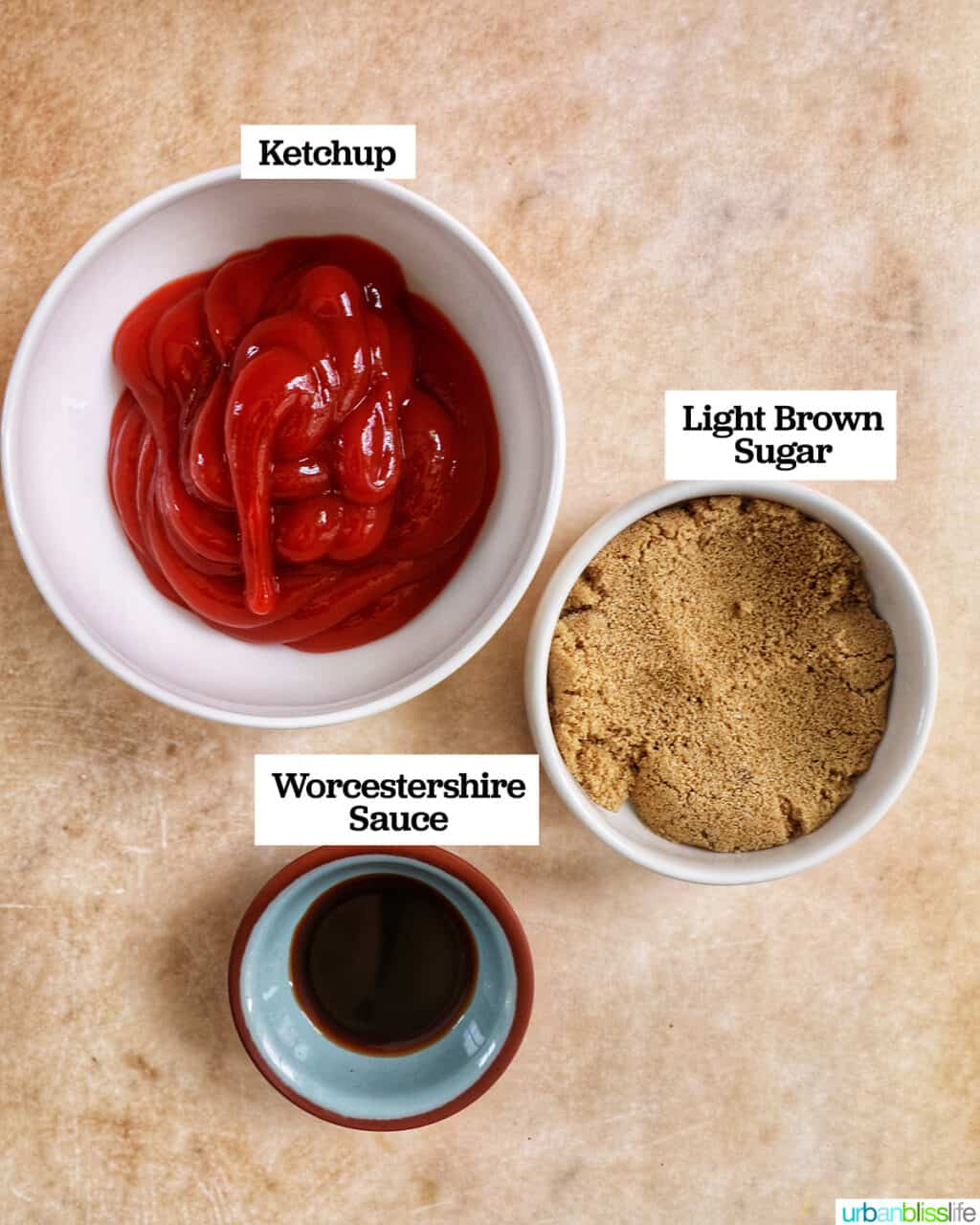 bowls with ketchup, brown sugar, and worcestershire sauce on a yellow table.
