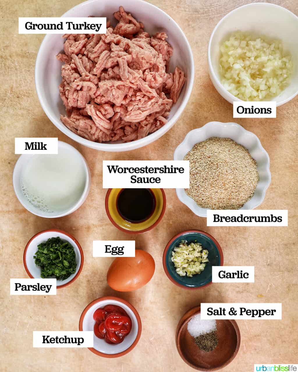 bowls of ingredients to make air fryer meatloaf on top of a yellow table.