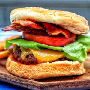 barbecue bacon burger with cheese and tomato.
