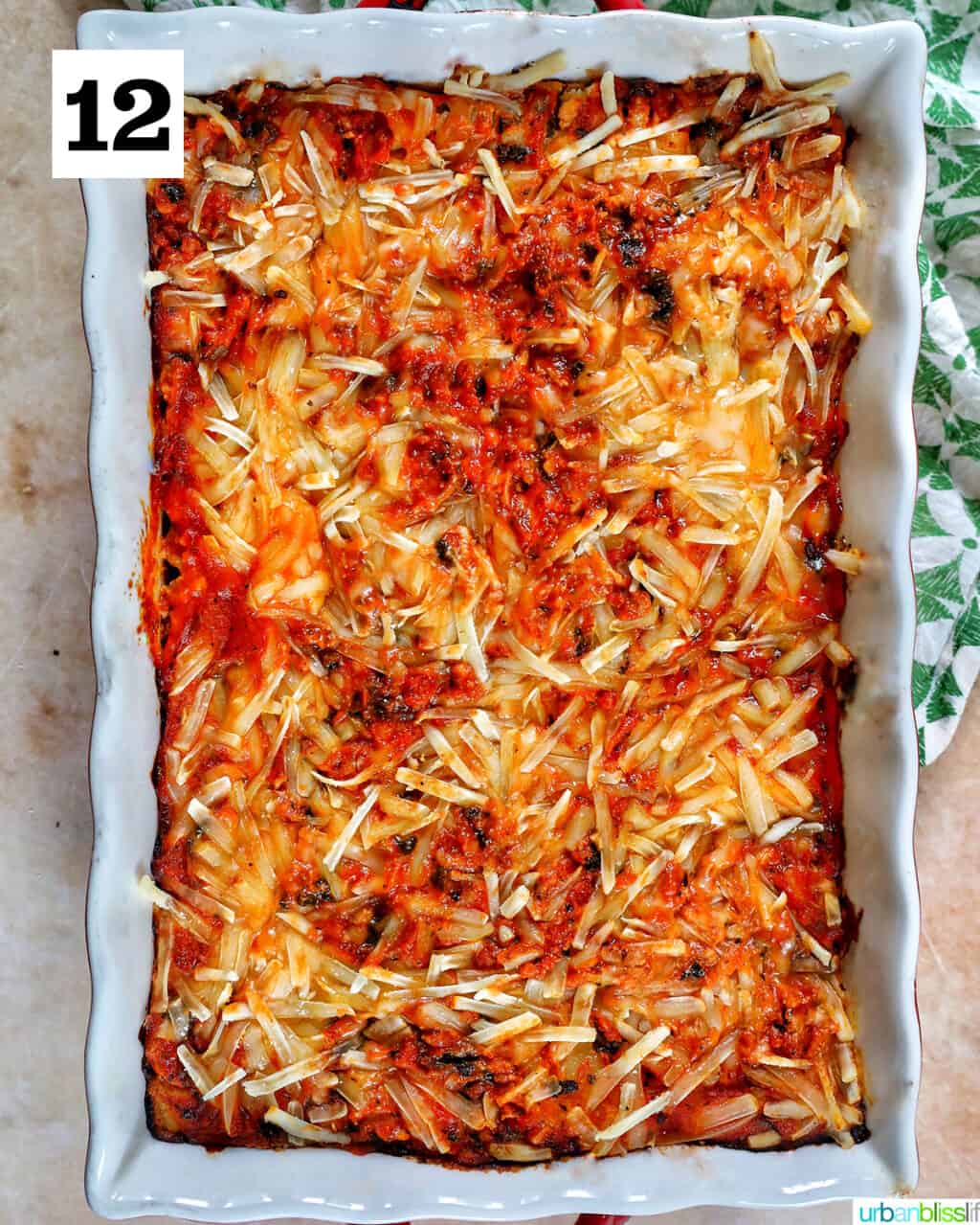 baking dish with baked dairy free lasagna inside topped with melty dairy free cheese.