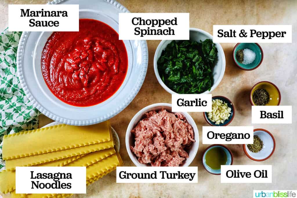 bowls of ingredients needed to make dairy free lasagna with ingredient labels on a yellow table.