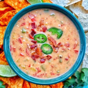 creamy dairy-free queso dip in a blue bowl.