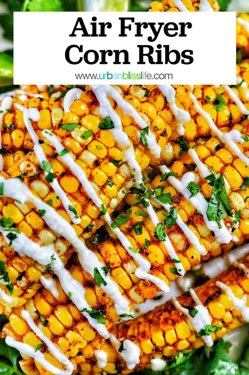 several air fryer corn ribs stacked on top of a bed of greens with drizzled mayo and chopped cilantro with title text overlay.
