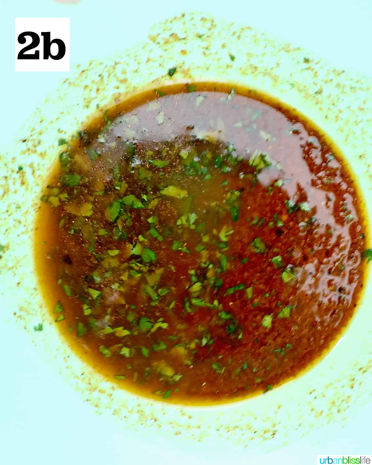 seasoned sauce in a green bowl to use for air fryer corn ribs.