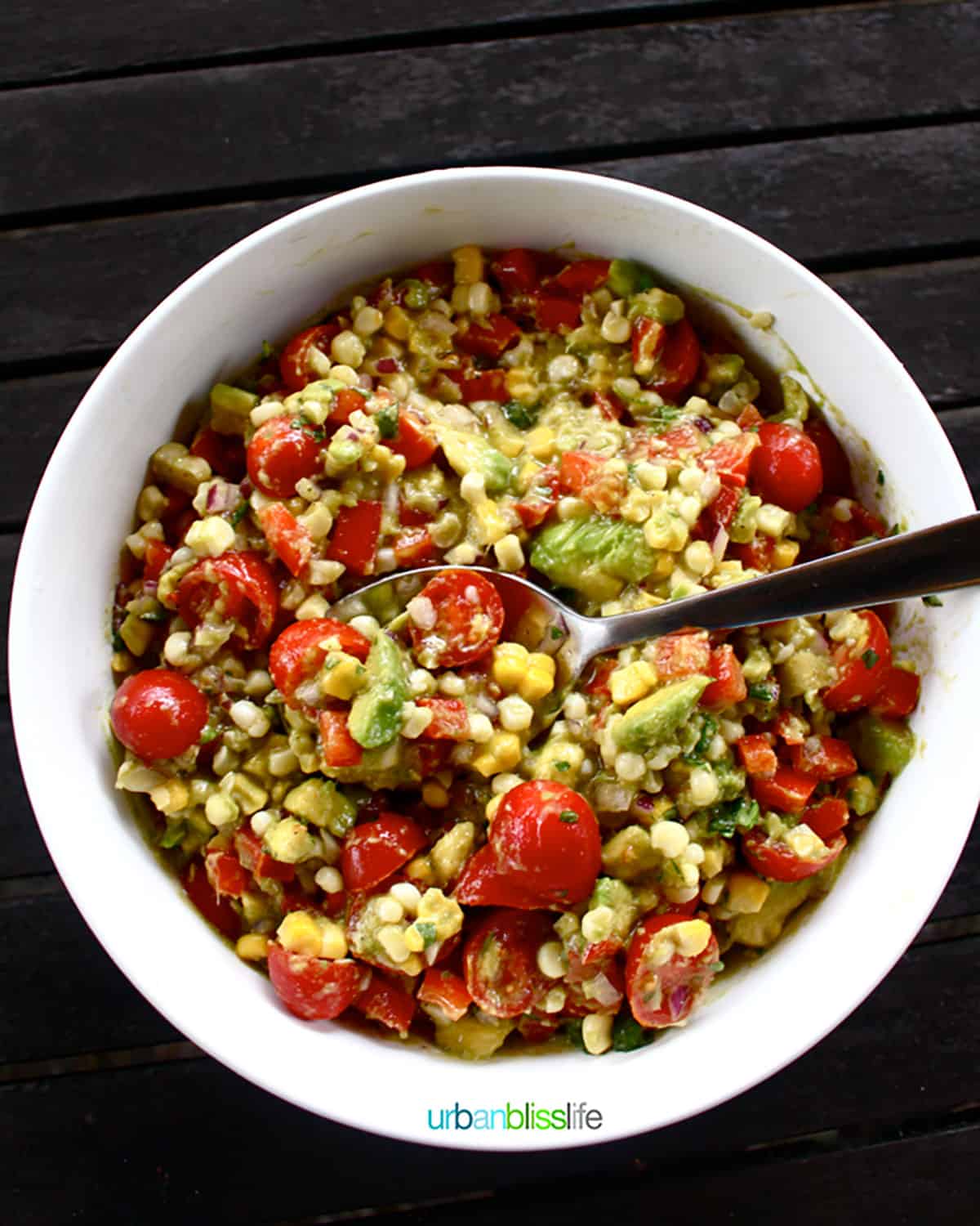 Avocado Corn Salad in a bowl with spoon.