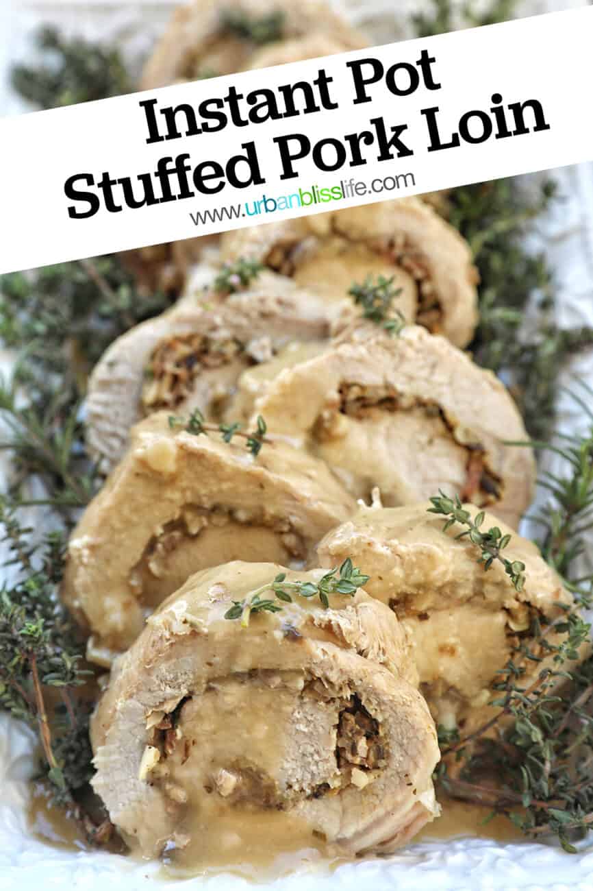 sliced stuffed pork loin on a white plate with a bed of herbs with title text overlay.