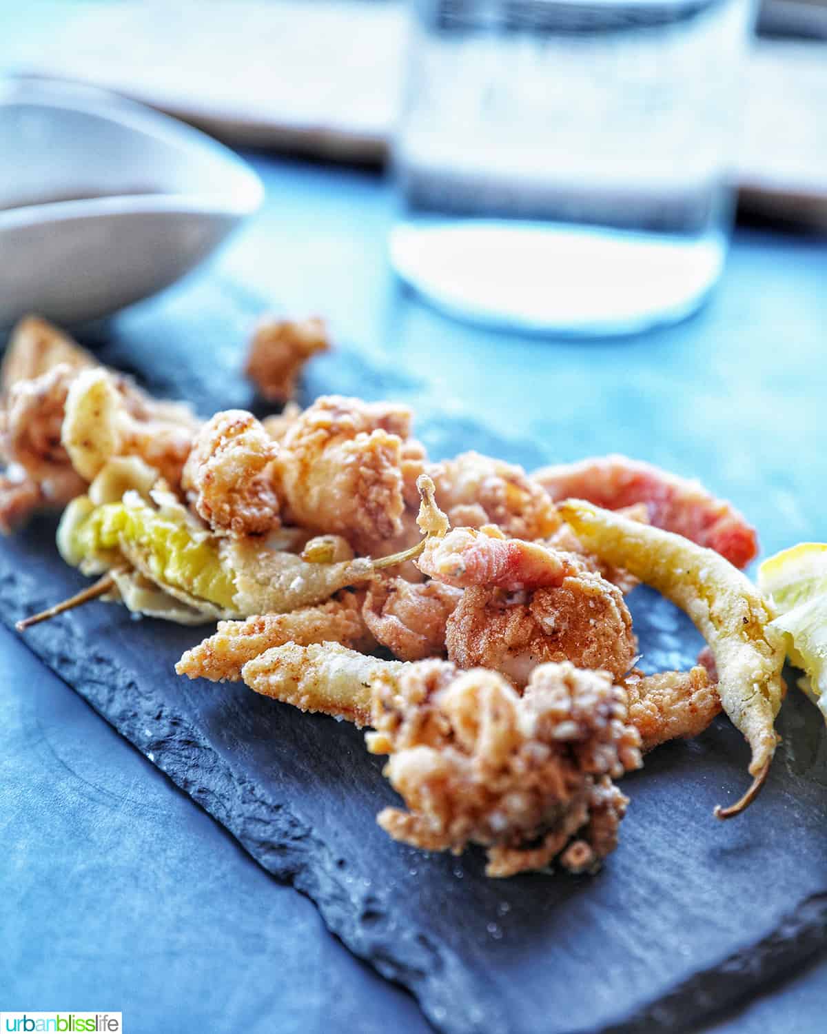 calamari on a black stone serving plate.