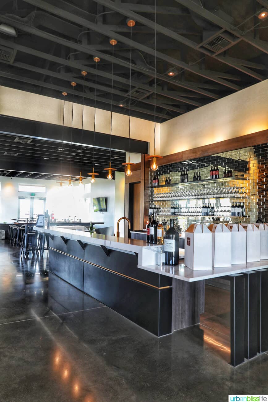 interior of Caprio Cellars, the bar area with dark wood floors.