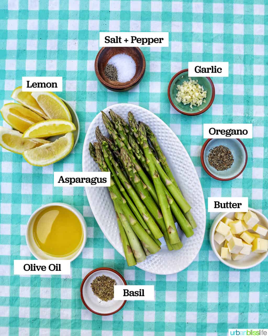 ingredients in bowls on a checkered tablecloth, to make grilled asparagus in foil.