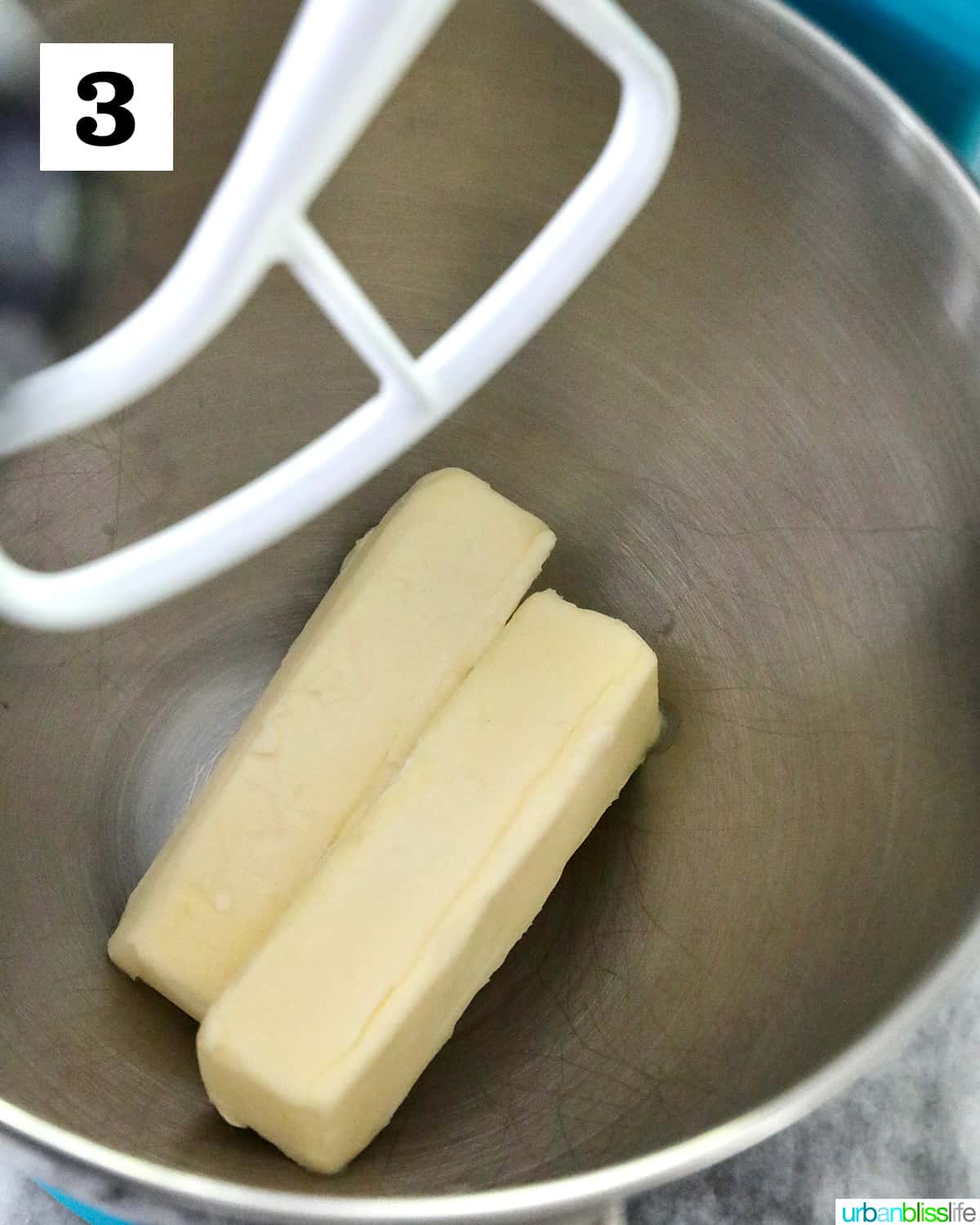 sticks of butter in the bowl of a stand mixer.