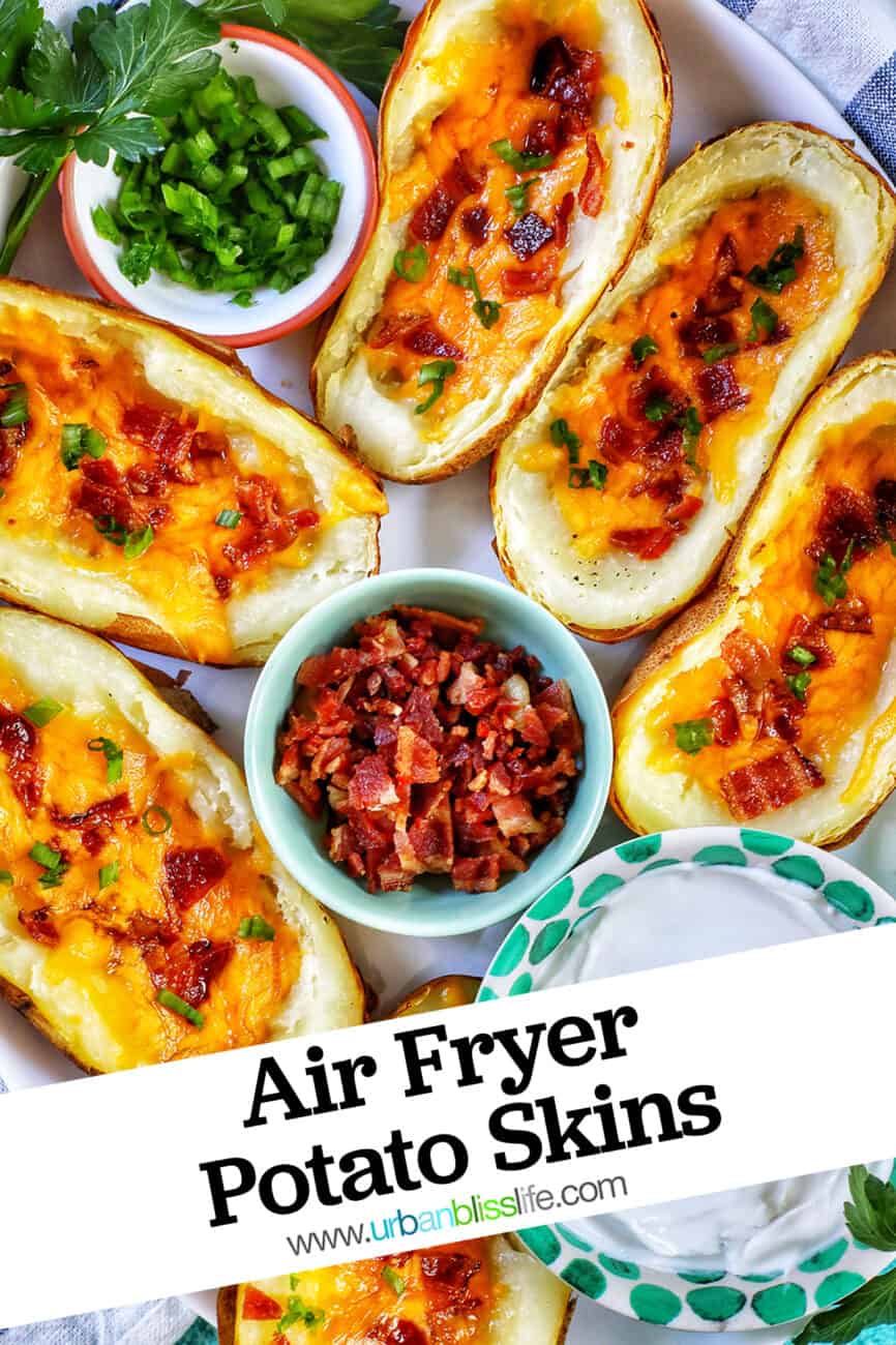 several air fryer potato skins with sides of green onions, bacon, and sour cream with title text overlay.