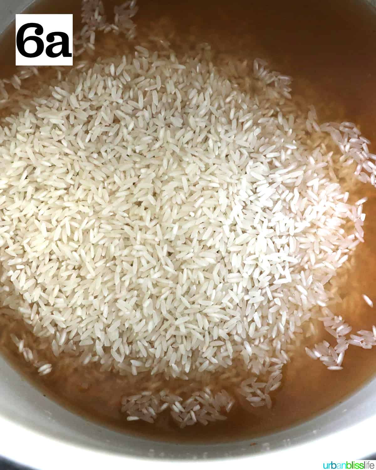 rice added to broth in a ninja foodi pressure cooker or instant pot.