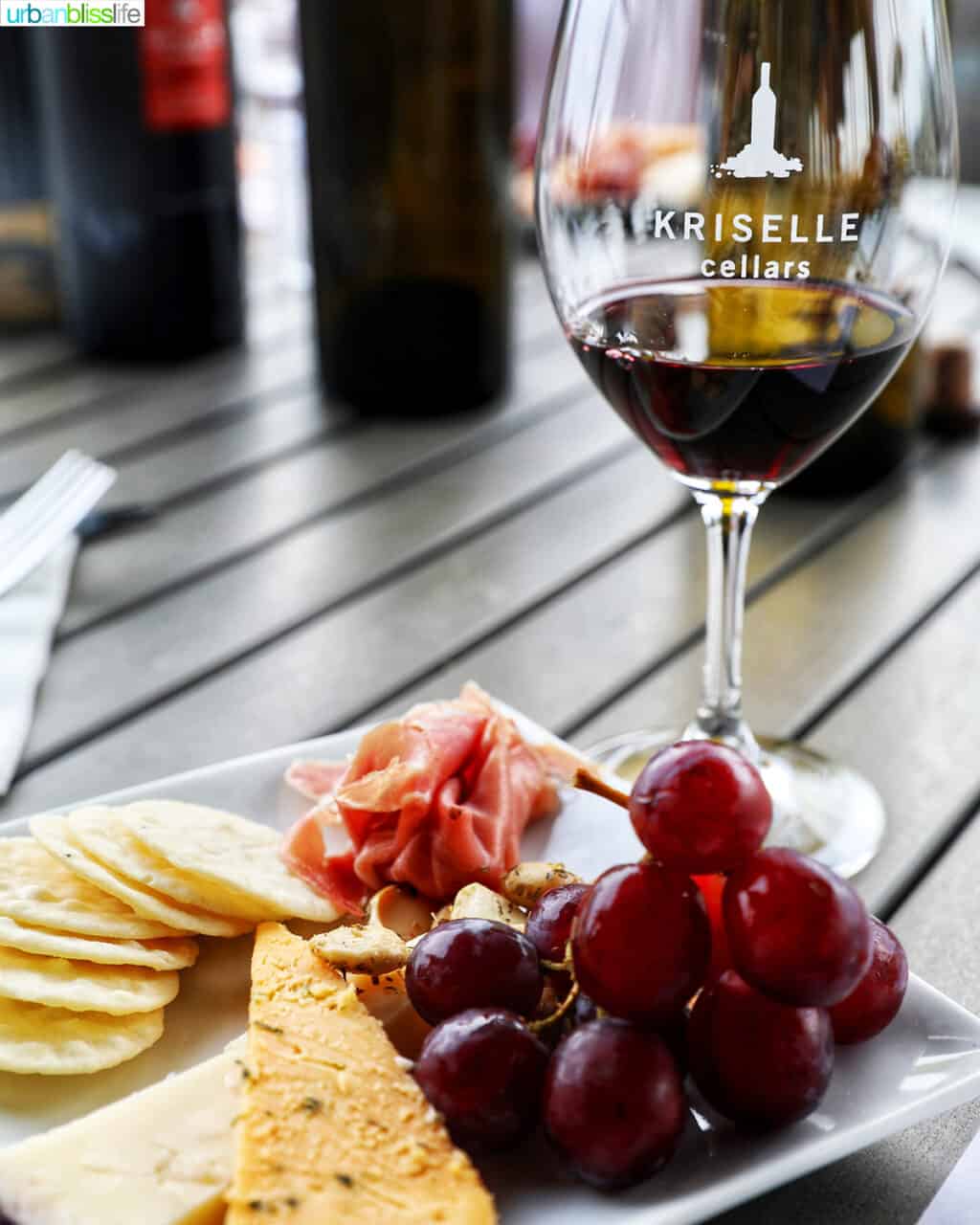 cheese and fruit plate with glass of red wine at Kriselle Cellars.