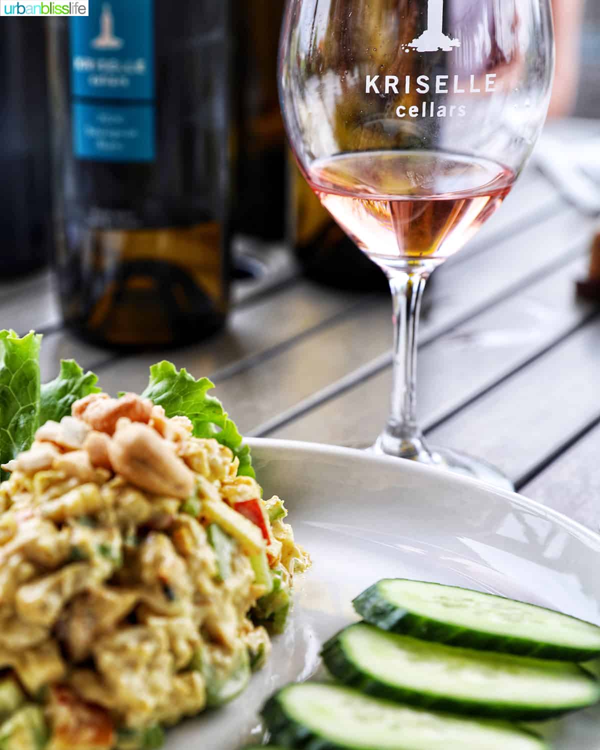 curry chicken salad, cucumbers, and a bottle and glass of Kriselle Cellars grenache rose.