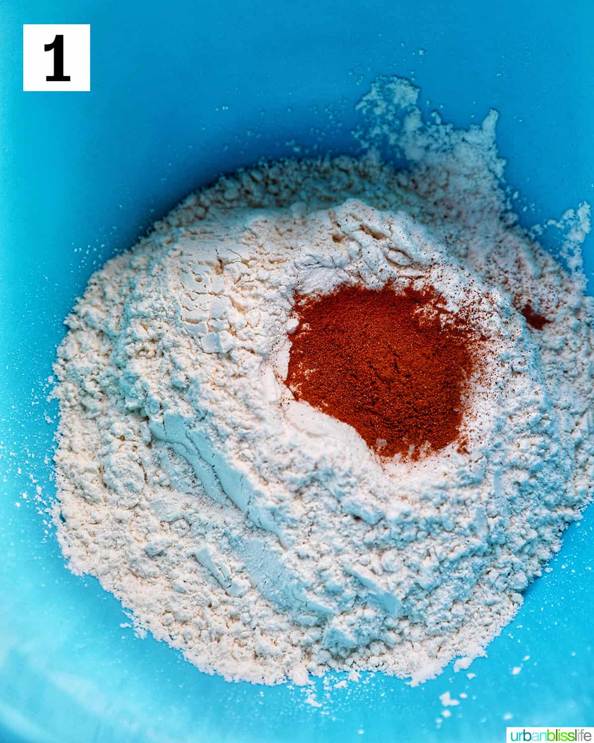 flour, cinnamon, salt, and baking powder in a blue bowl.