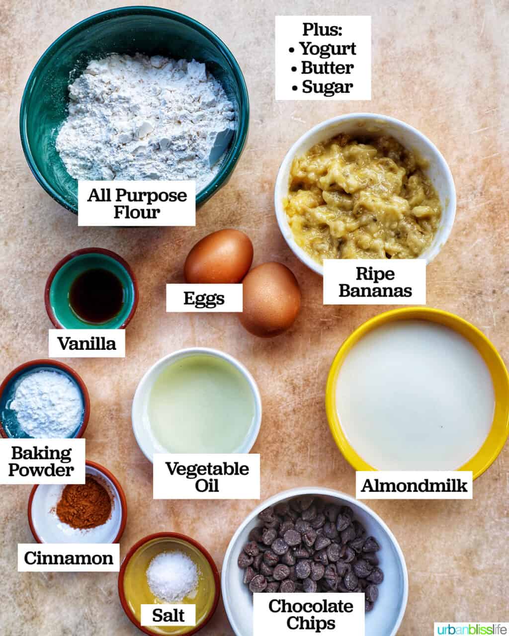 bowls of ingredients needed to bake banana chocolate chip muffins.