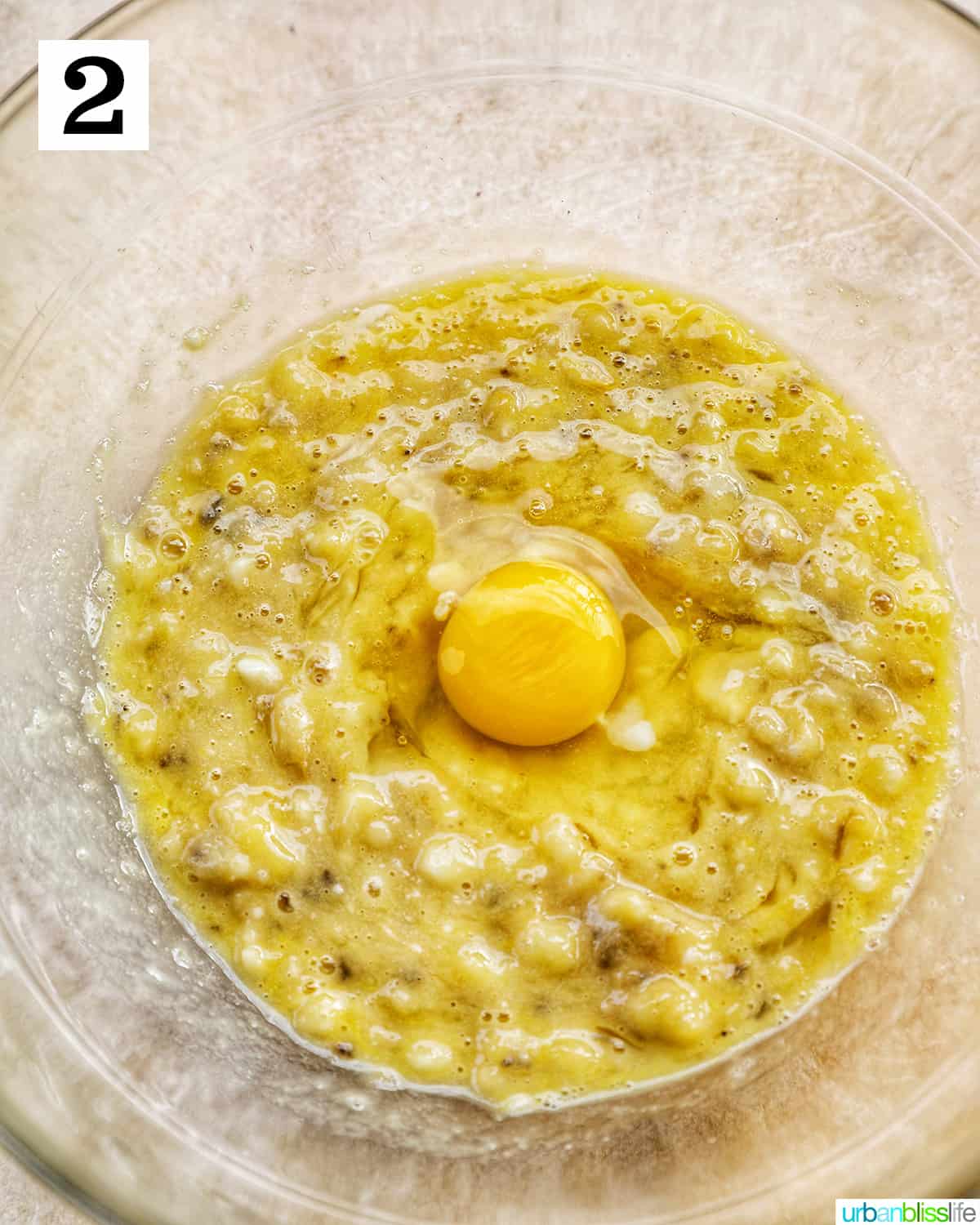 mashed bananas with eggs in a clear bowl.