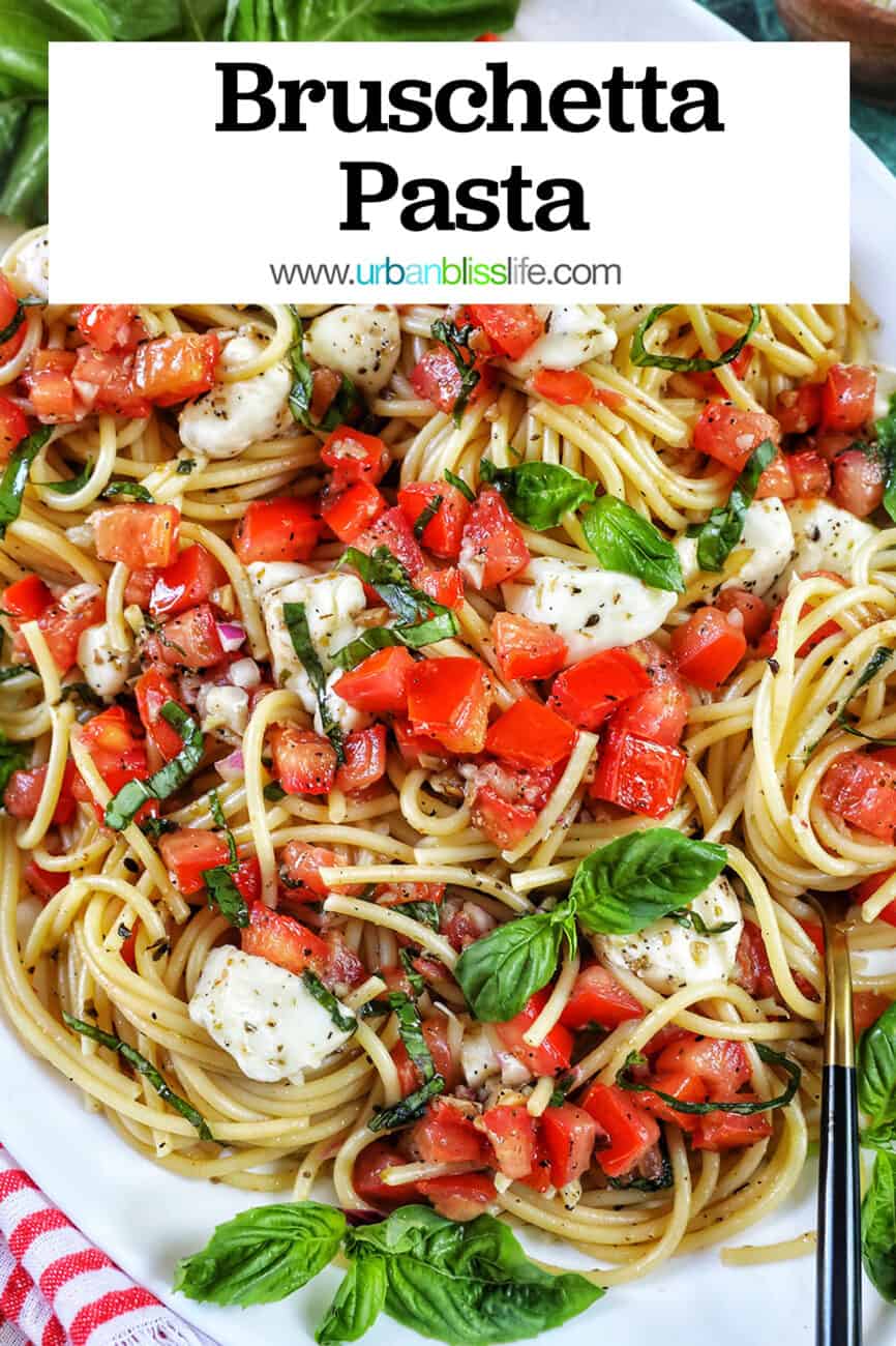 bruschetta pasta with tomatoes, basil, mozzarella cheese in a big white serving bowl with title text overlay.