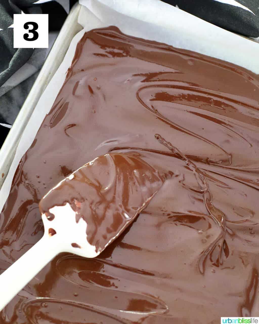 spreading melted chocolate in sheetpan