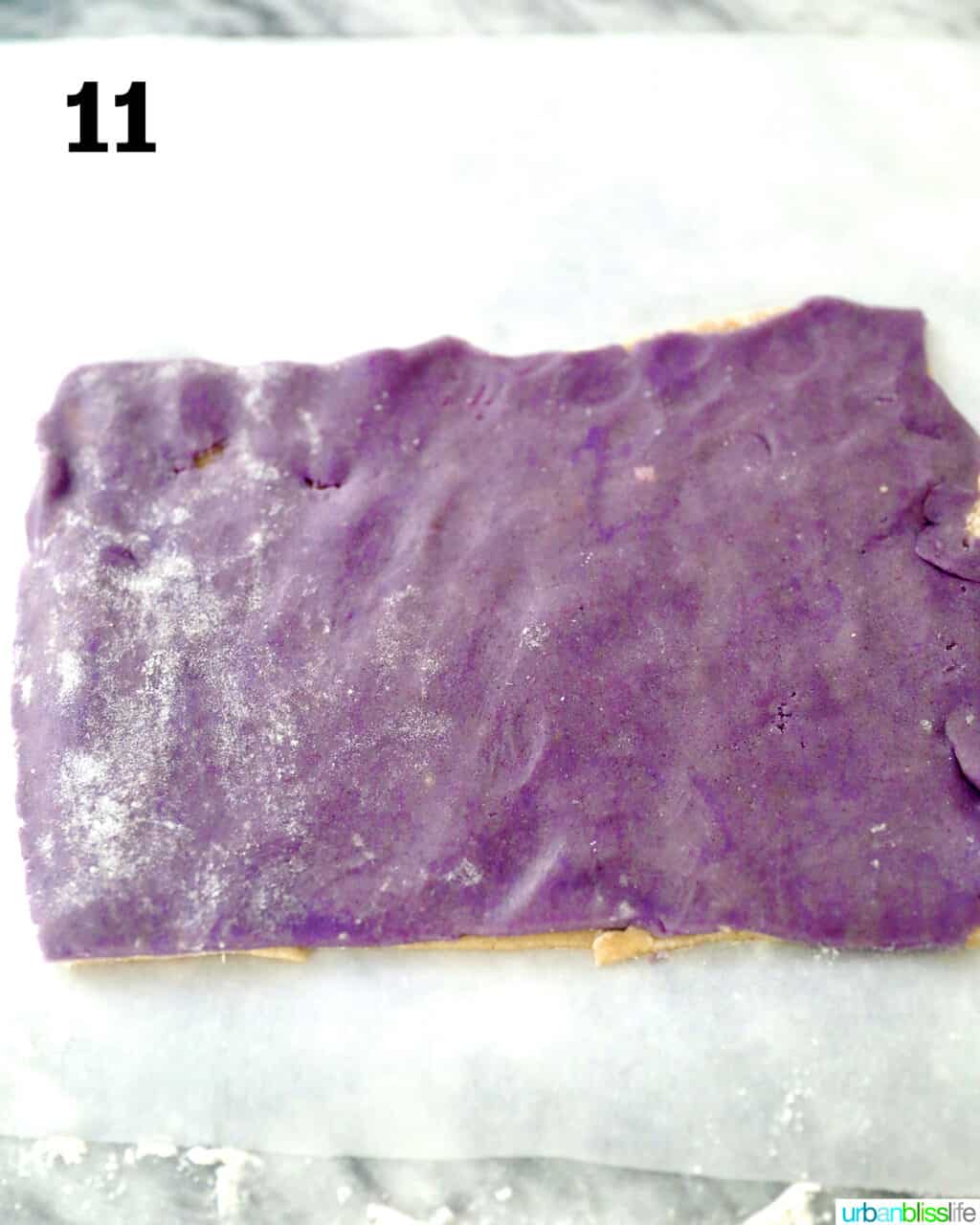 purple dough rolled out flat over cookie dough