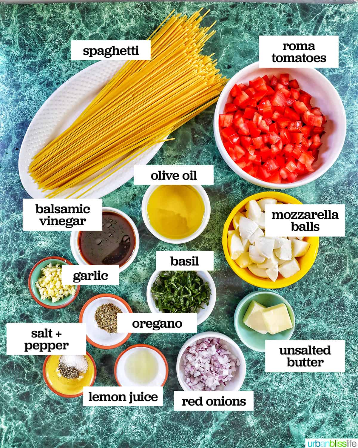 bowls of several ingredients to make bruschetta pasta on a green table.