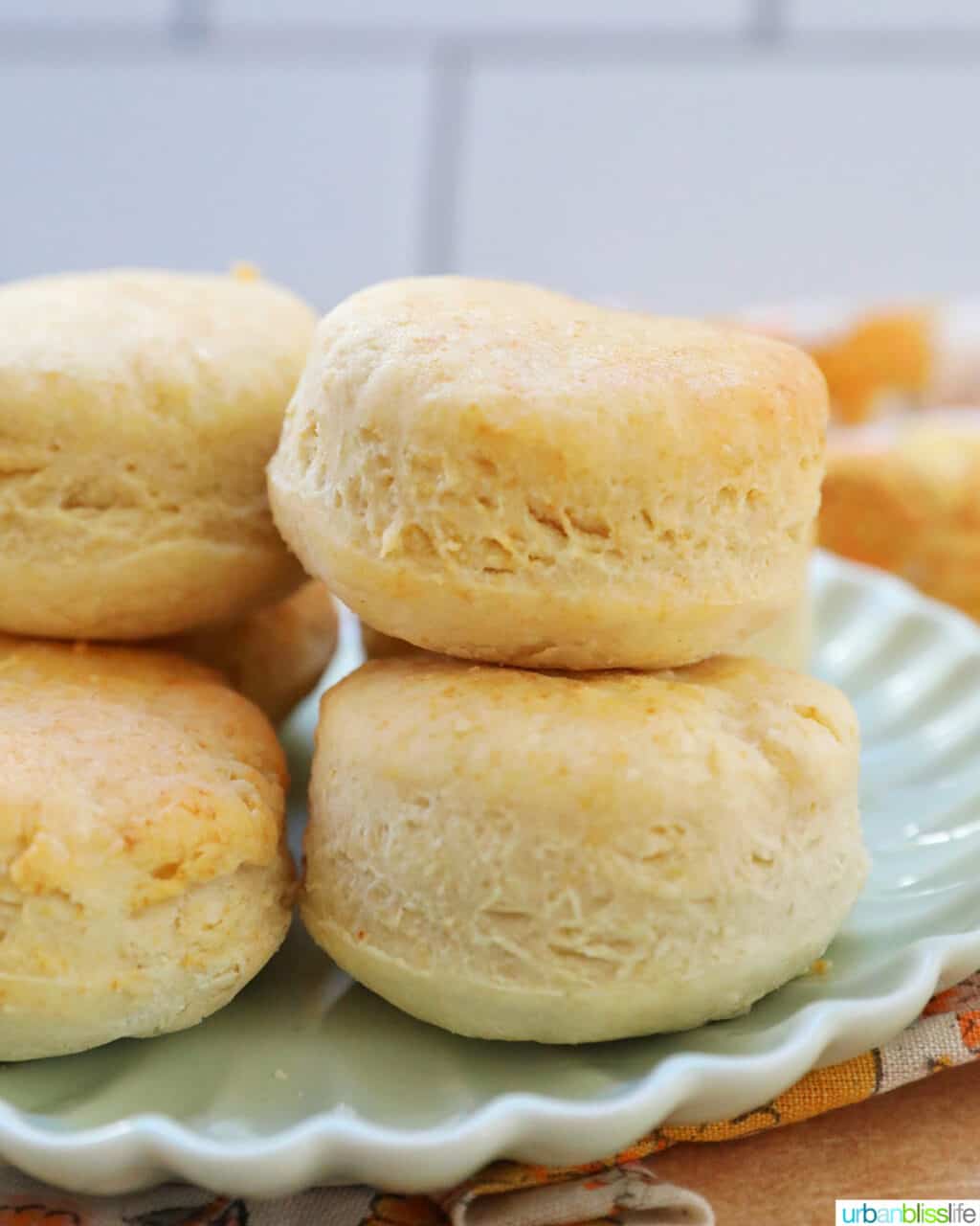 air fryer biscuits stacked on a plate.