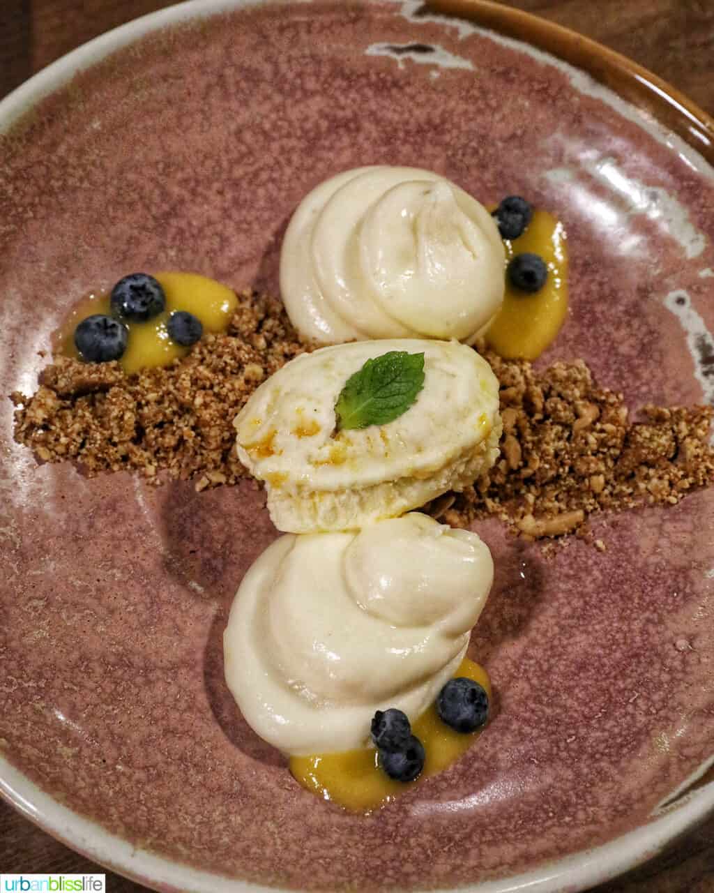 deconstructed cheesecake on a beige plate with blerries.