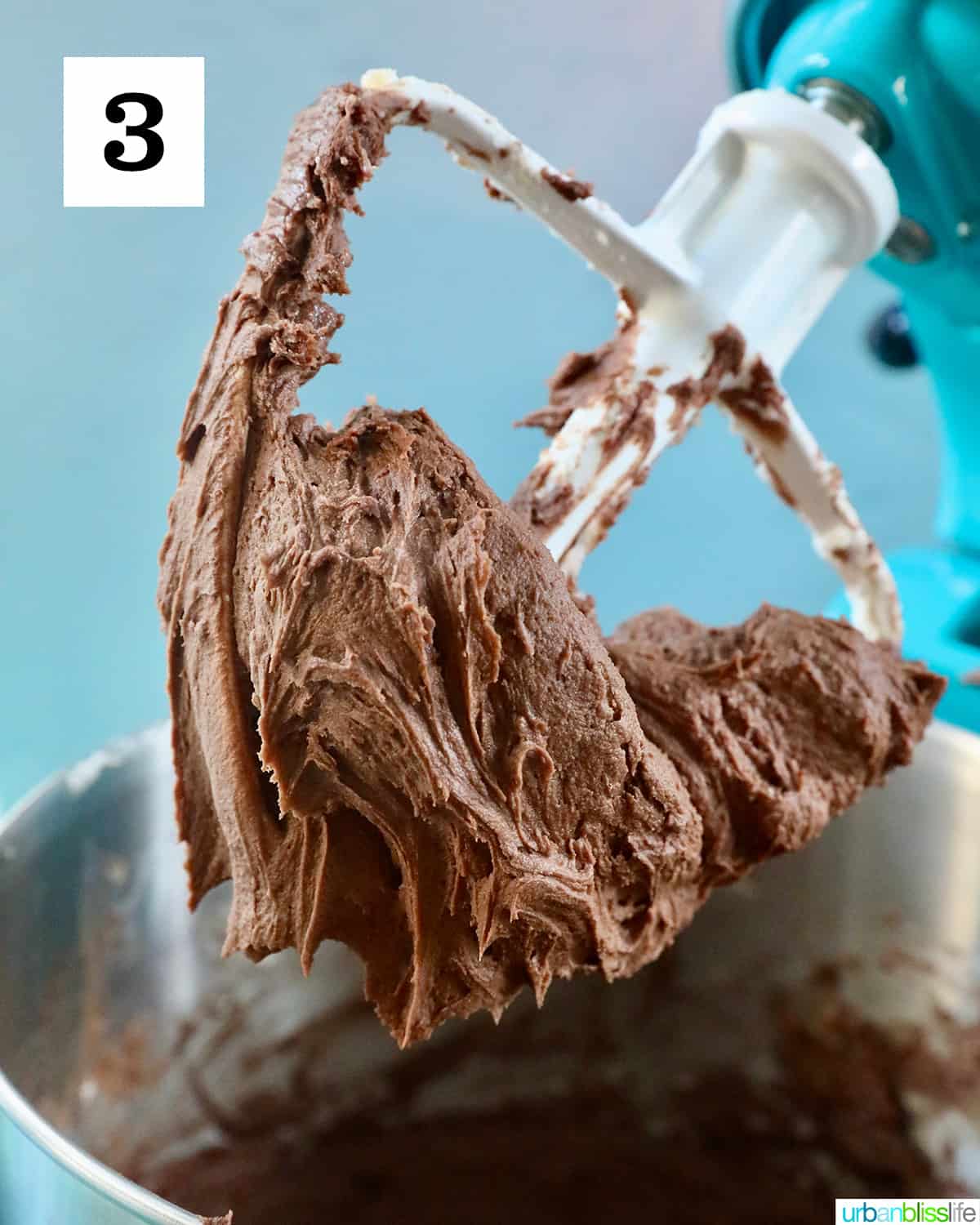 chocolate buttercream frosting on a stand mixer paddle.