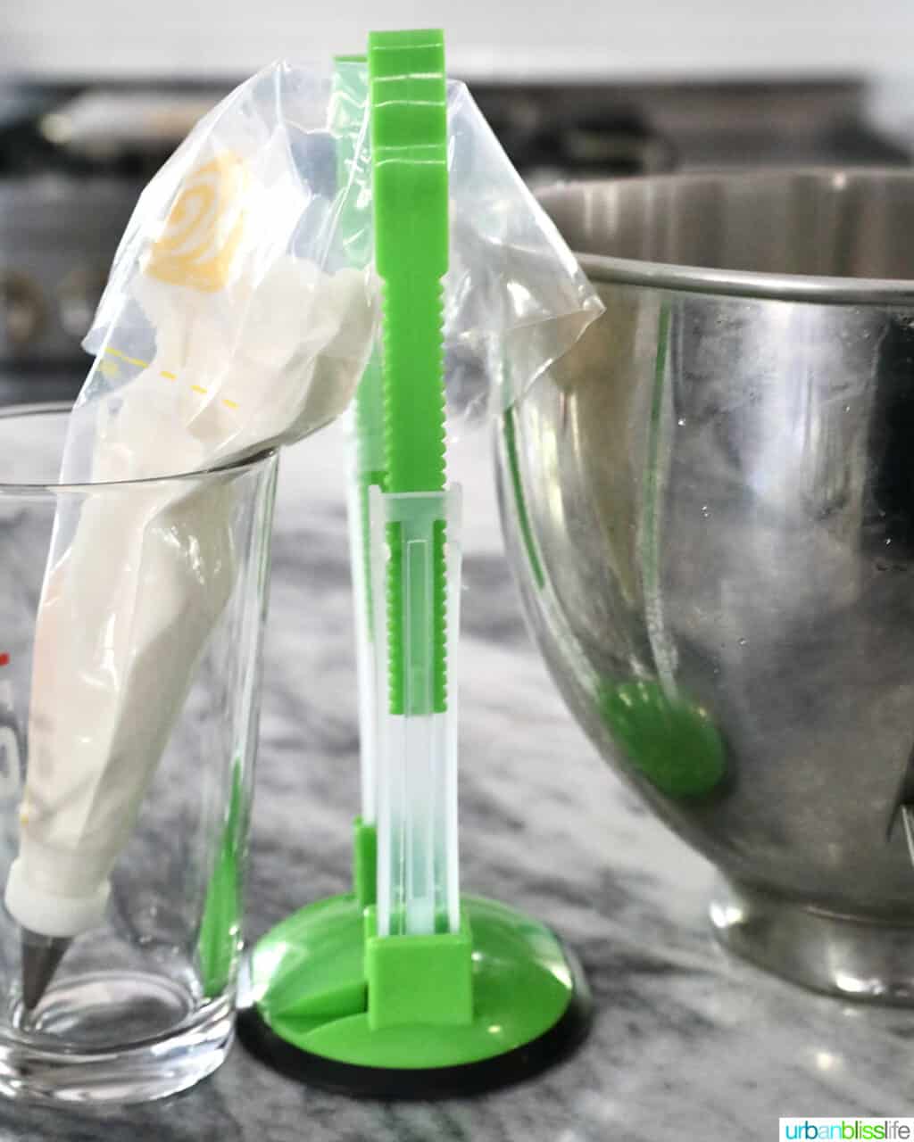 royal icing in a piping bag with bag stand and stainless steel bowl.