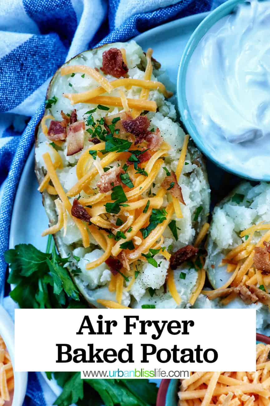 Loaded air fryer baked potato with title text overlay and sides of sour cream, cheddar cheese, parsley, and bacon.