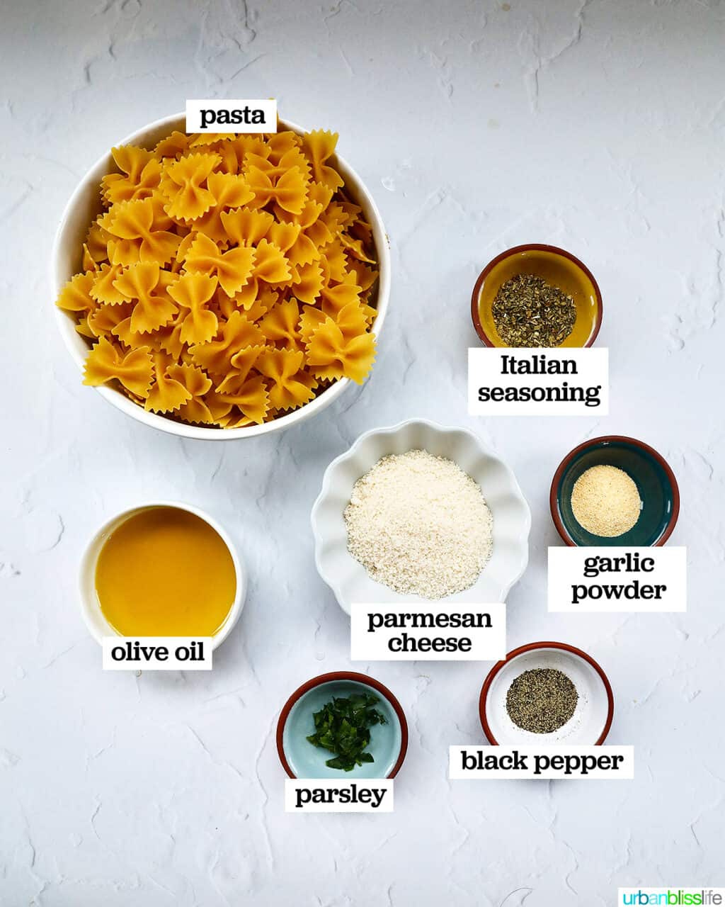 bowl of ingredients to make air fryer pasta chips on a white table.