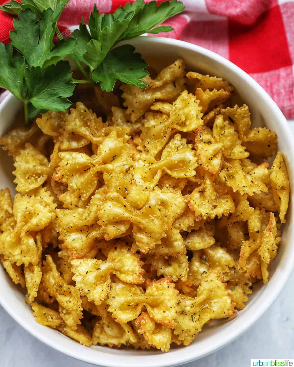 bowl of Air Fryer Pasta Chips in a white bowl with parsley.