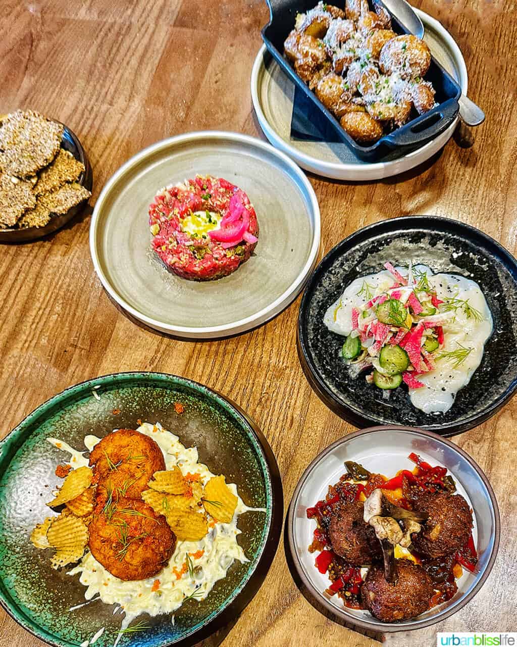 several dinner dishes on a table at Brazen Banff restaurant.