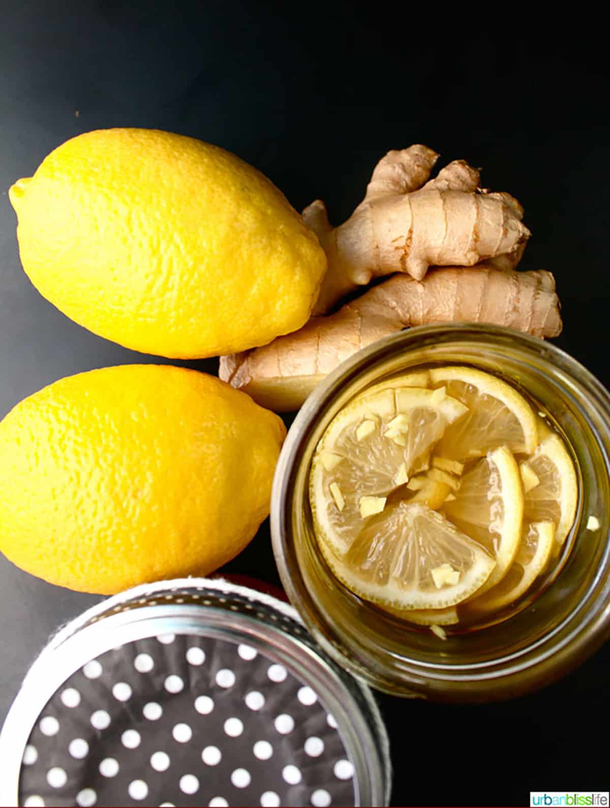 lemon, ginger and honey syrup with two fresh lemons and fresh ginger