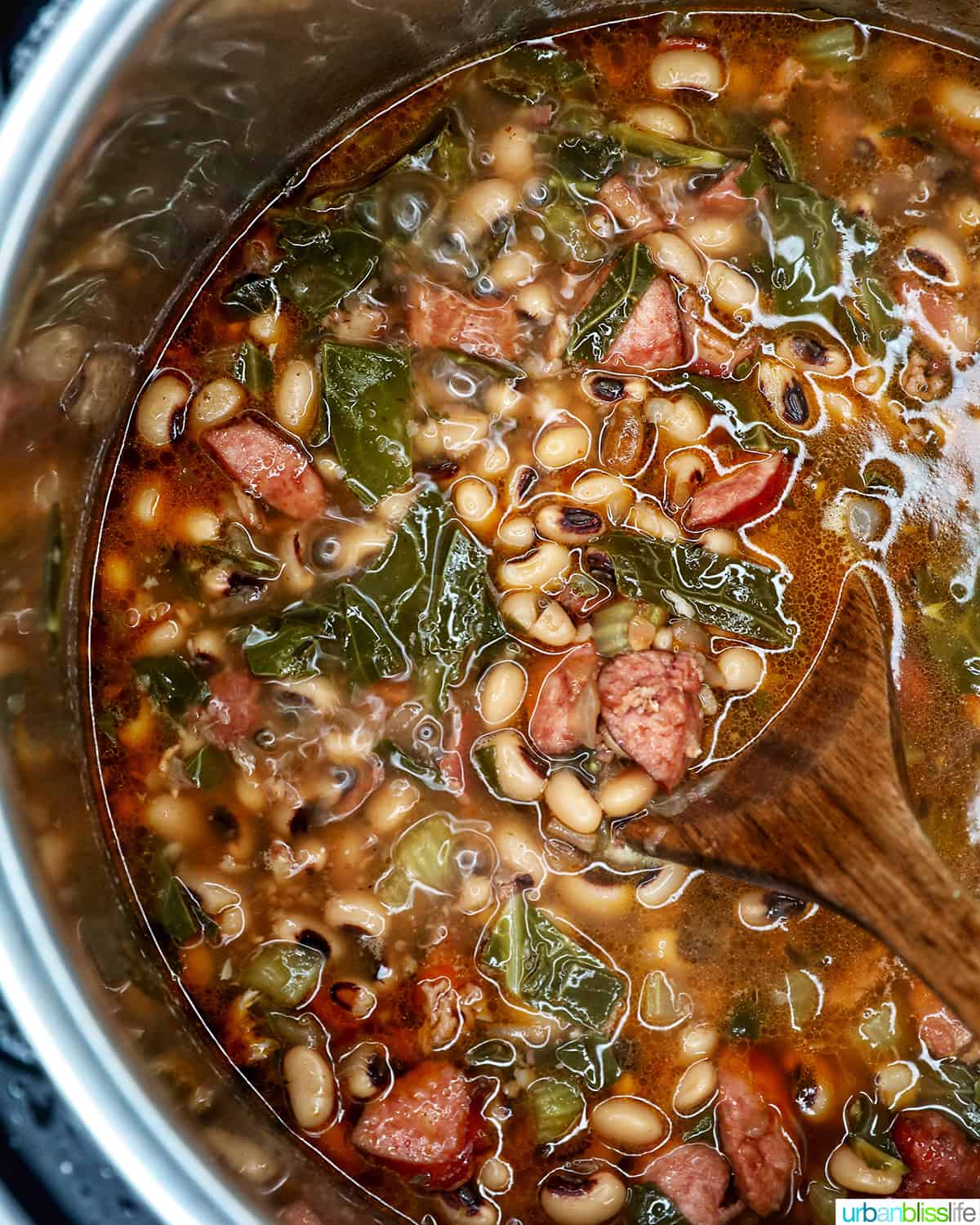 black eyed peas with collard greens, bacon, sausage, and vegetables in broth, in the Instant Pot.