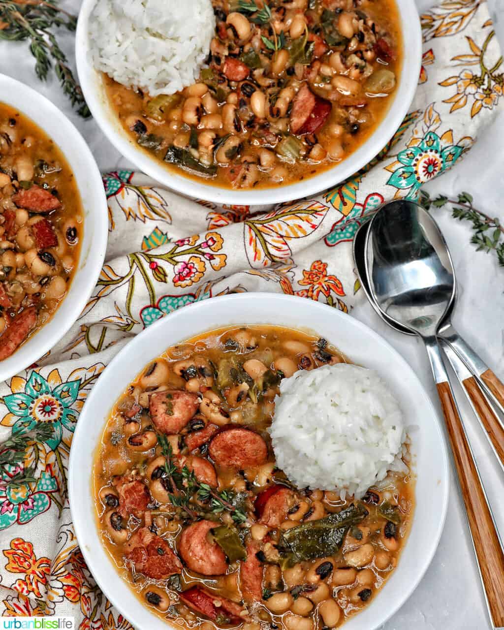 Instant Pot black eyed peas with scoop of white rice in white bowls.