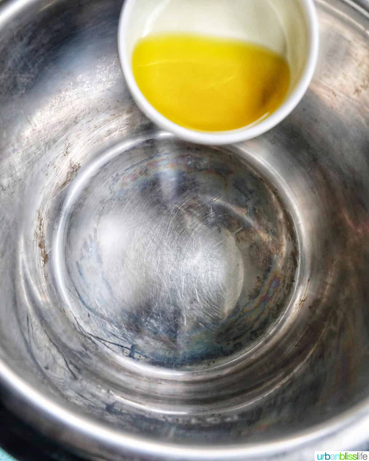 adding olive oil to the Instant Pot.