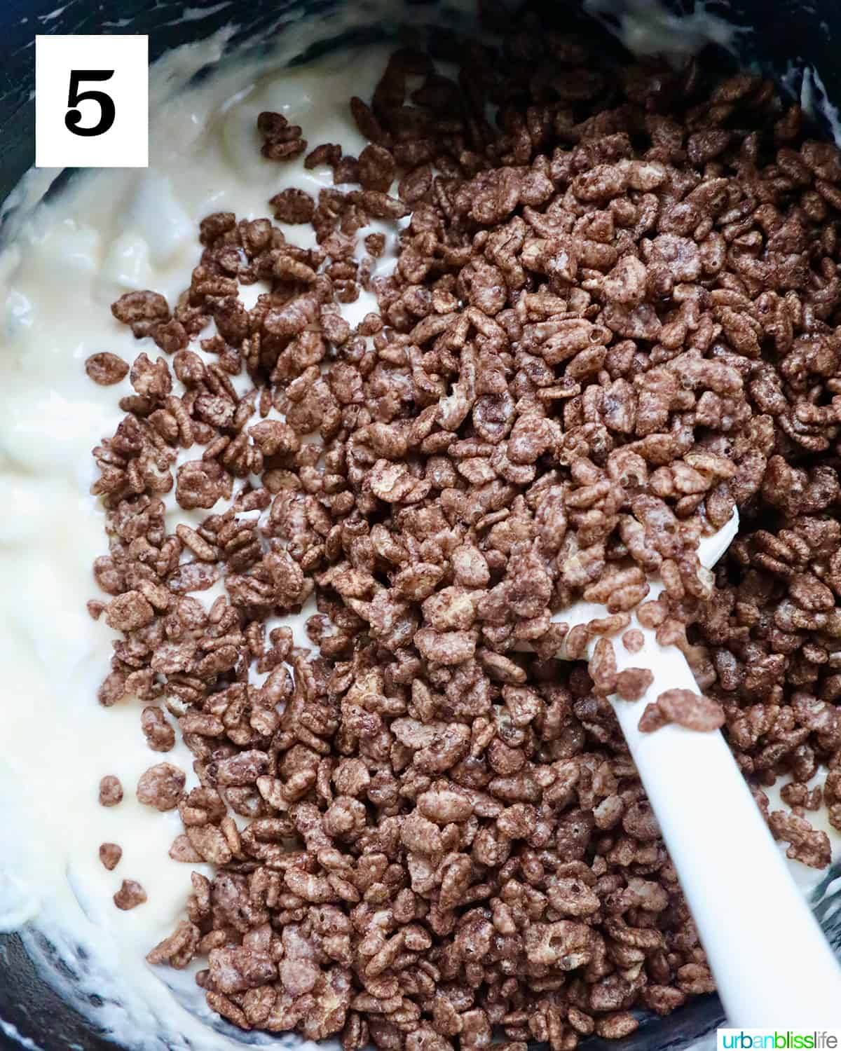 folding in chocolate rice krispies and marshmallows