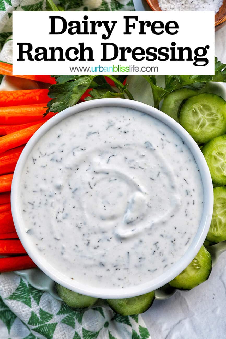 bowl of dairy free ranch dressing with carrot sticks, cucumber slices, and herbs with title text overlay.