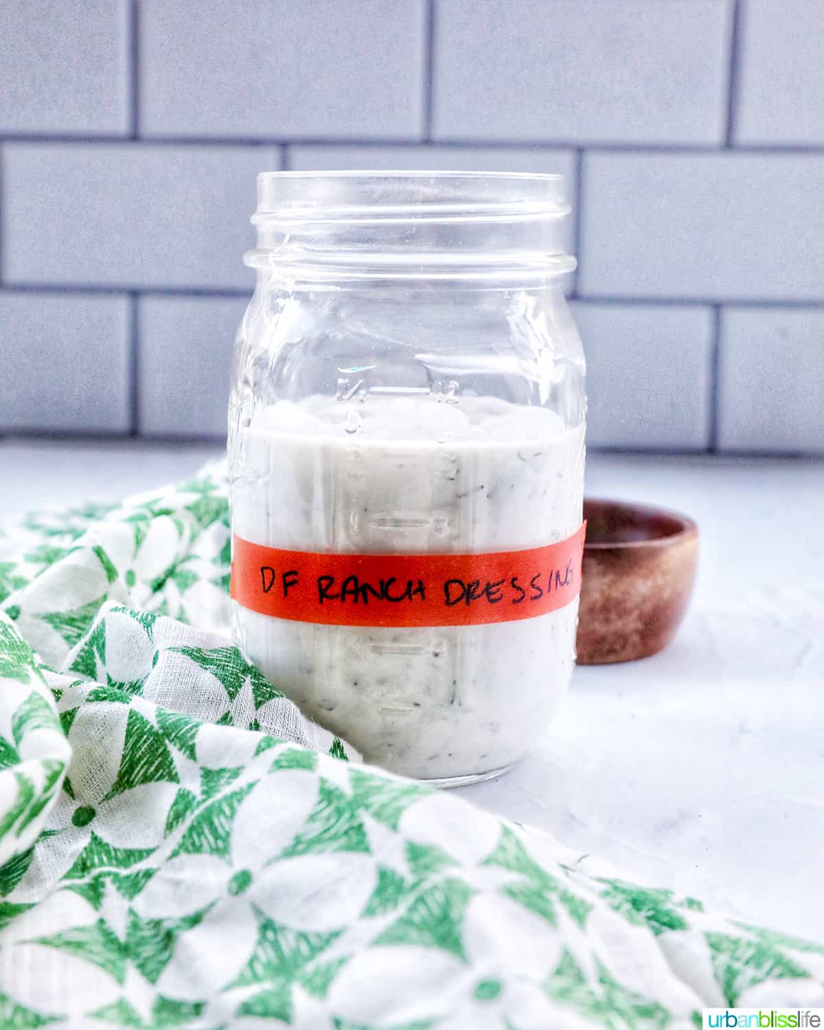 dairy free ranch dressing in a labeled mason jar with green and cream napkin.