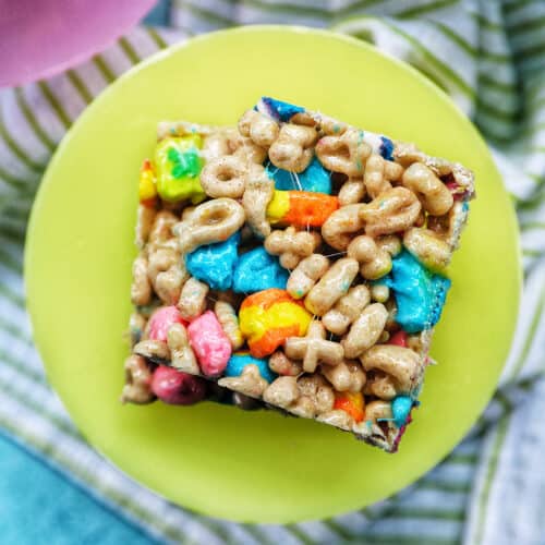 overhead photo of stacked lucky charms cereal bars on a green plate.