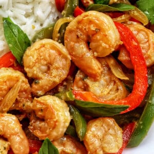 Thai Basil Shrimp with red and green peppers on a bed of rice.