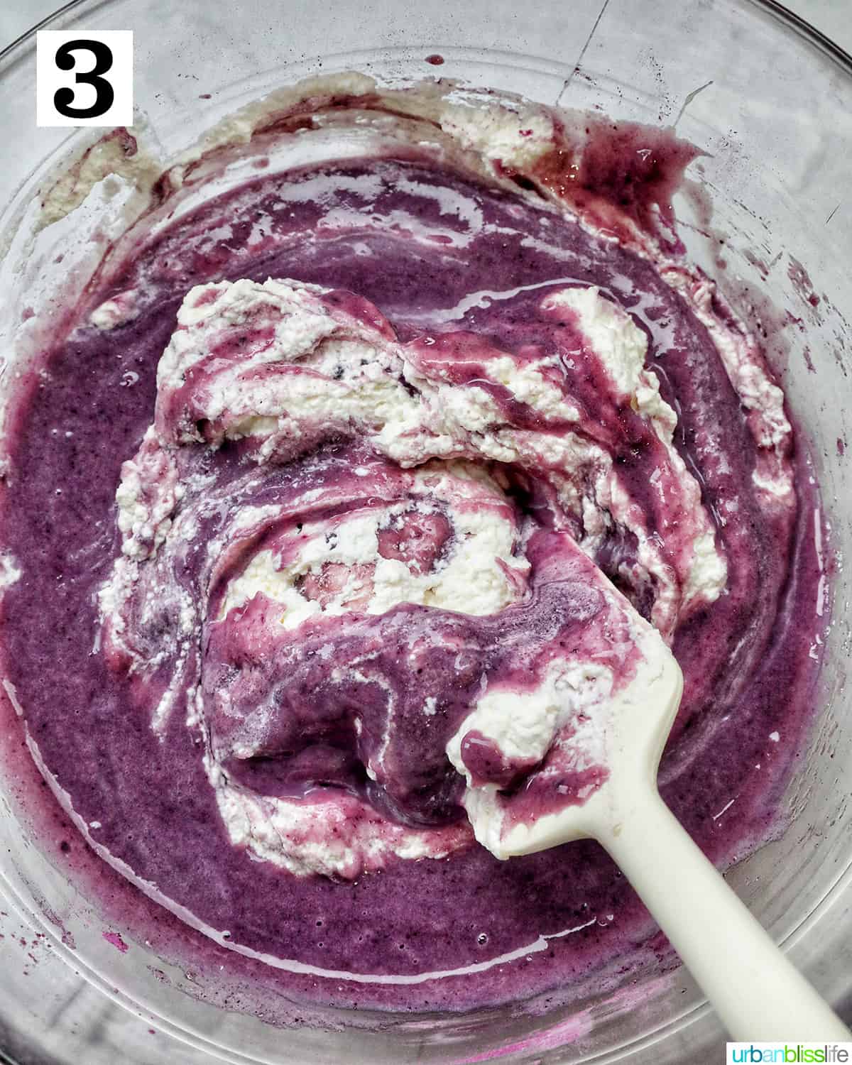 folding in whipped cream to the ube ice cream base.