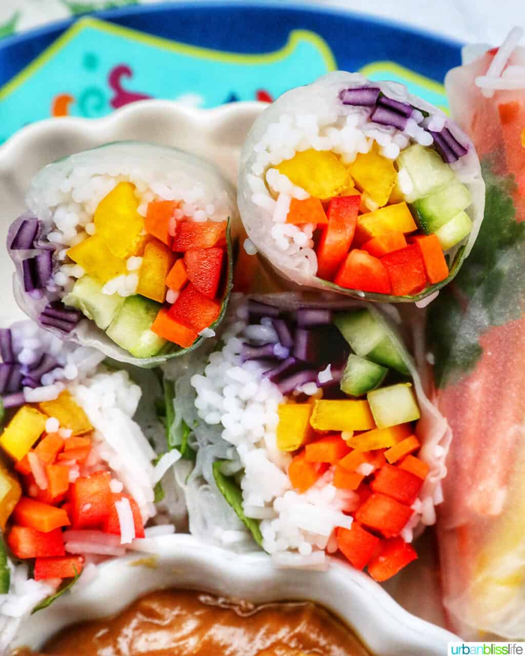 vegan summer rolls cut in half showing the vegetables and vermicelli noodles