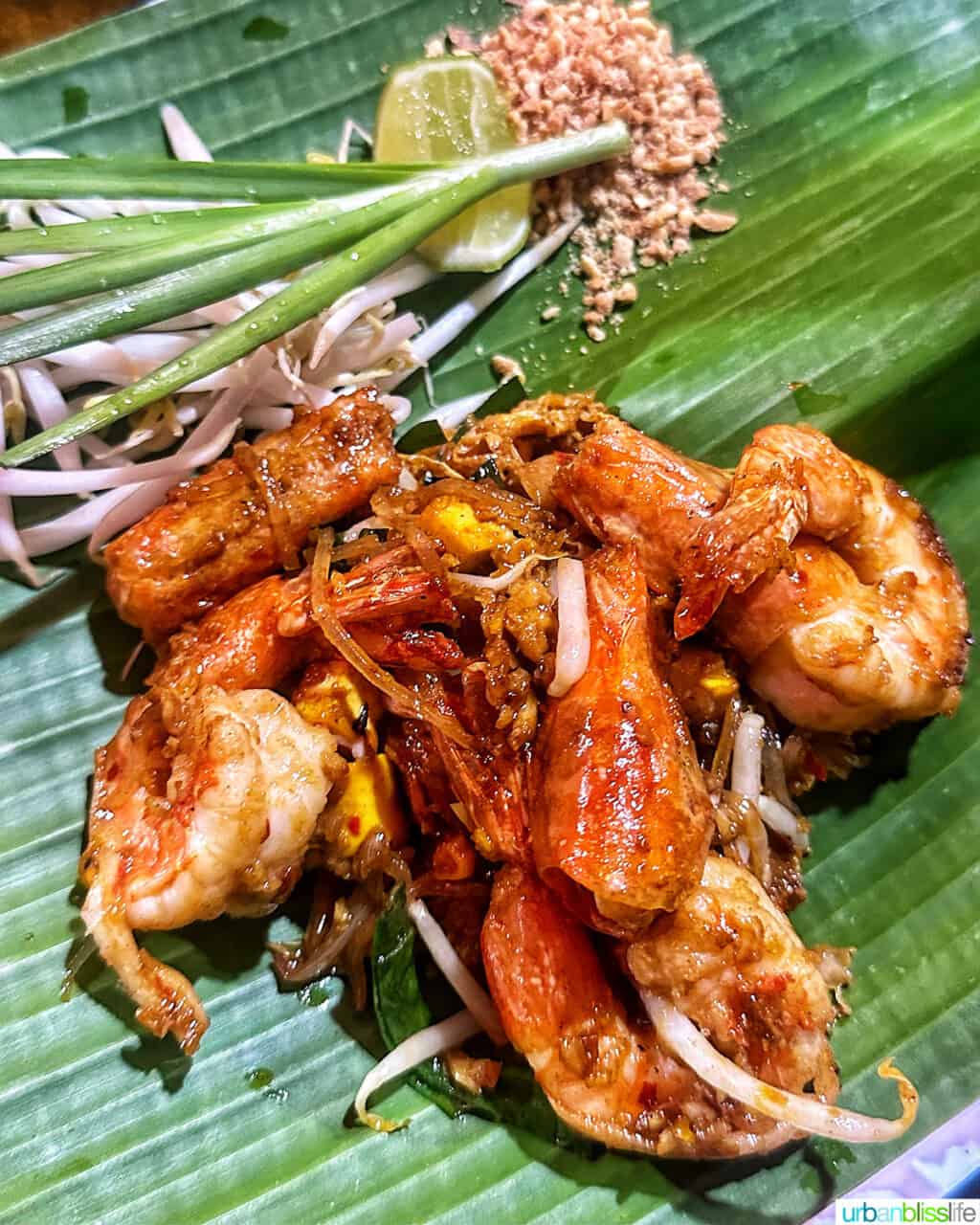 shrimp pad thai in Bangkok, on a bed of banana leaves.