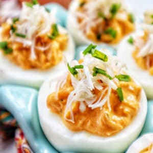 closeup of crab deviled eggs in a blue egg holder.